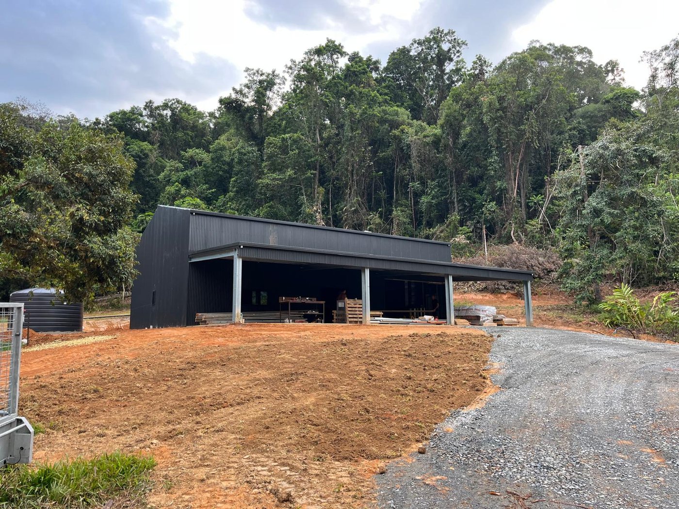 Completed shed with open bay and driveway access